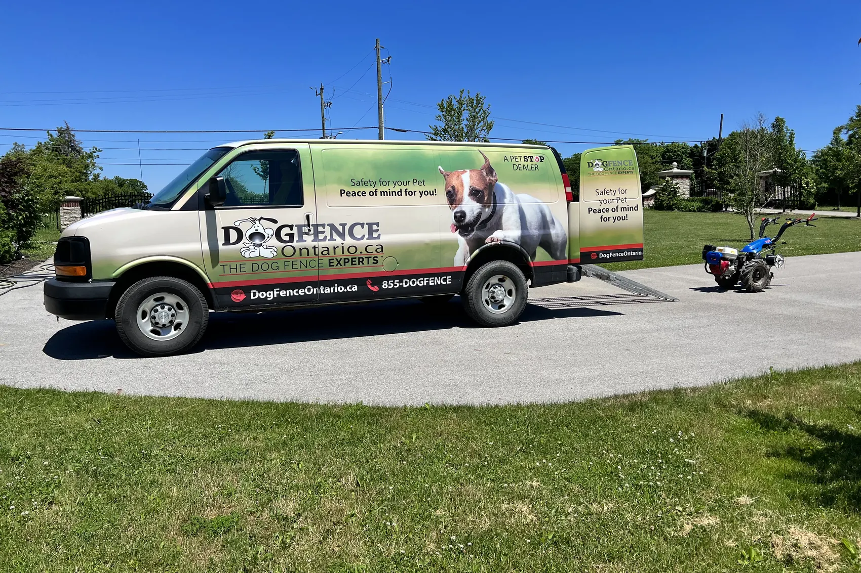 The Dog Fence Ontario van and trencher in a customer's driveway on install day