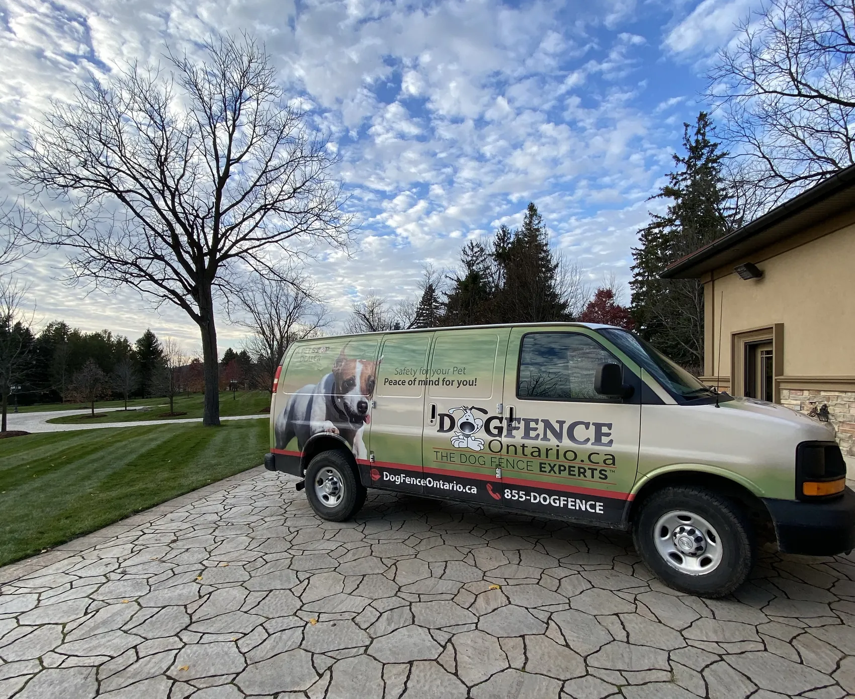 The Dog Fence Ontario van in a customer's driveway