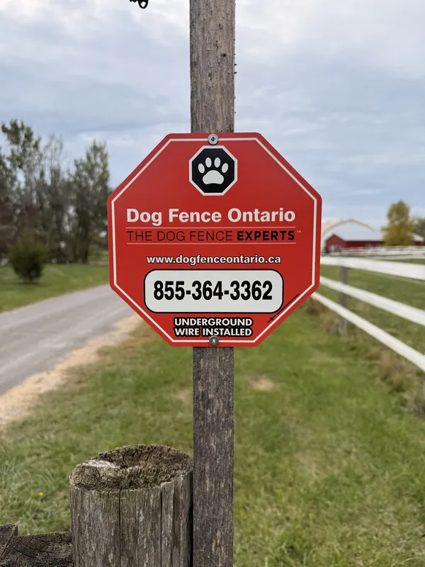 Dog Fence Ontario underground wire installed sign on fence post at a Niagara property