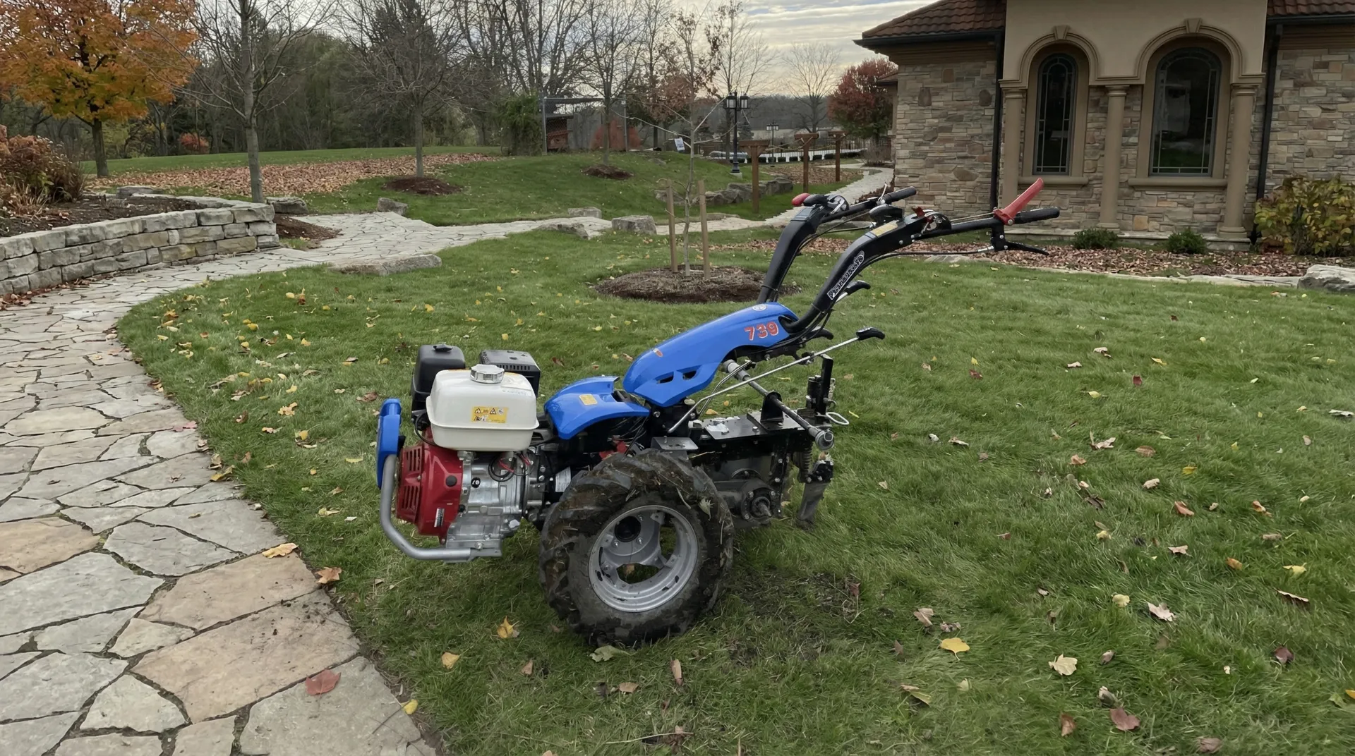 Professional wire trenching equipment on a green lawn during an invisible fence installation